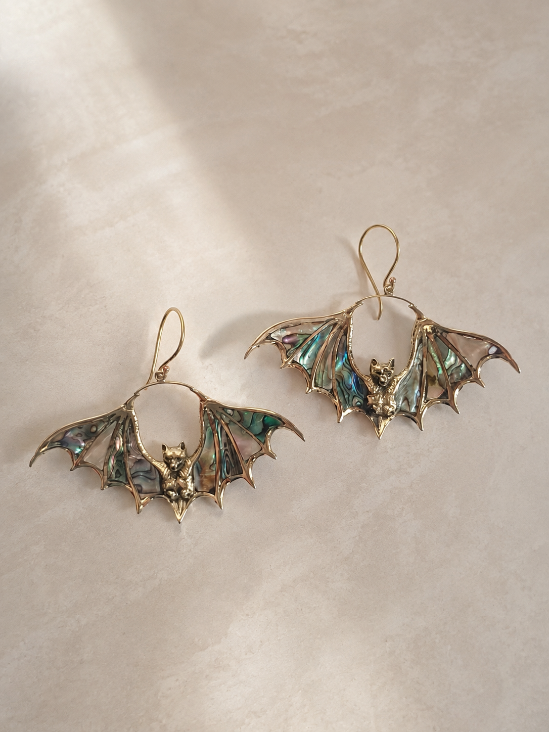 Nocturne golden brass bat earrings with iridescent Abalone Shell wings