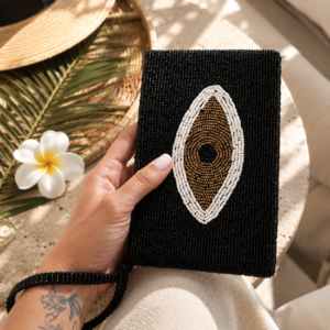 Noir Eye black hand-beaded clutch with ivory and bronze Evil Eye motif