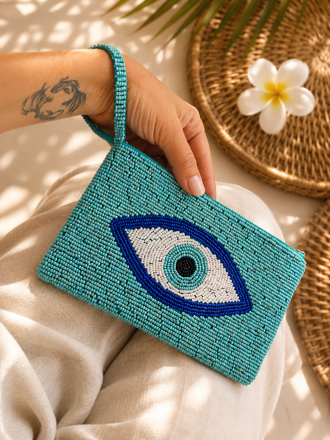 Azure Eye turquoise hand-beaded clutch with blue and white eye motif