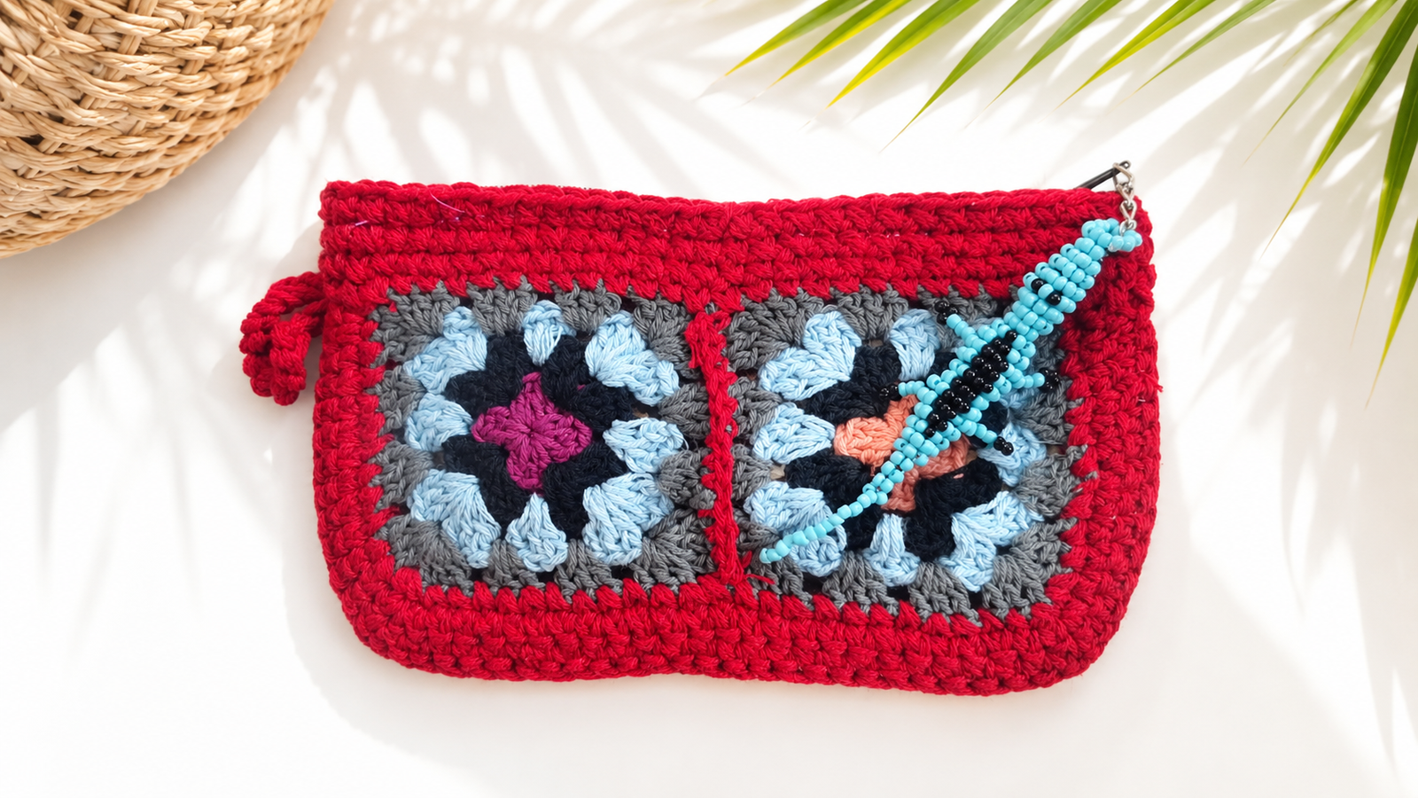 Coral handmade red crochet clutch with colourful granny squares and turquoise beaded gecko