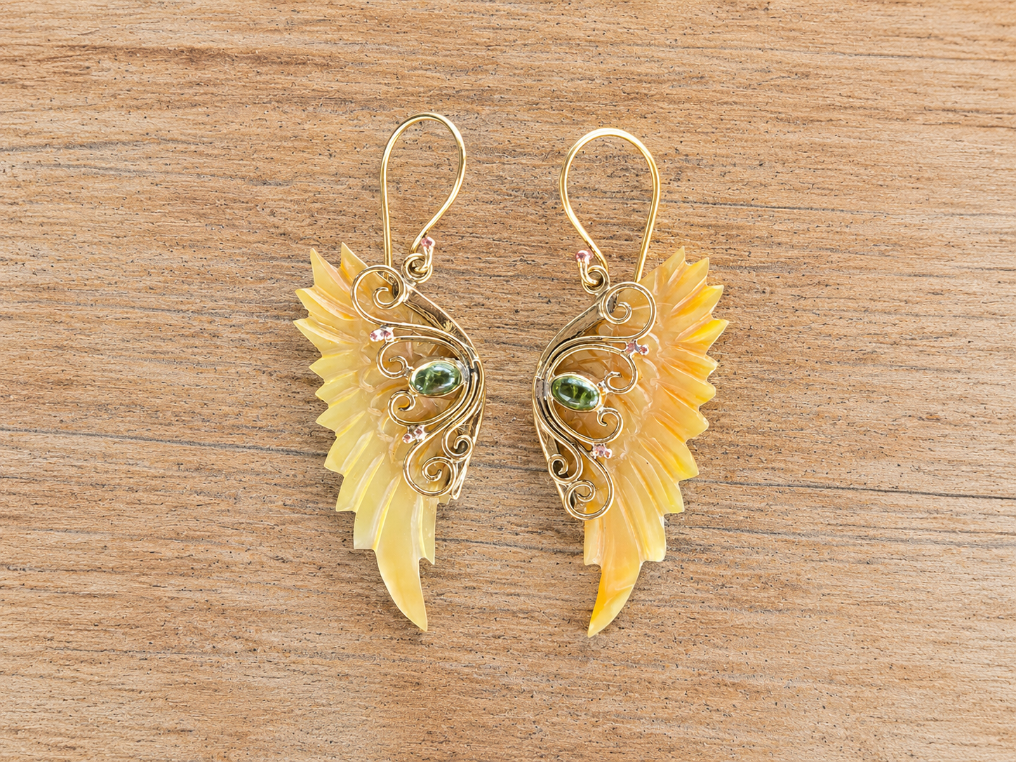 Solara Wings brass earrings with carved Mother of Pearl wings and green gemstones
