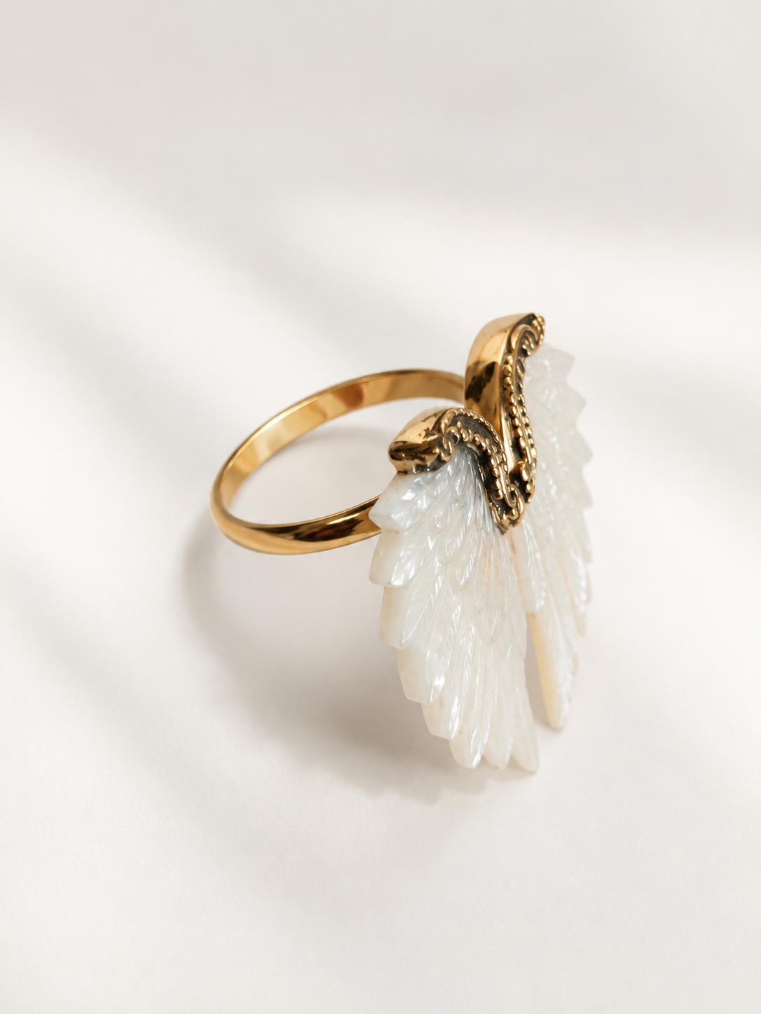 Seraphine golden brass ring with carved Mother of Pearl wings