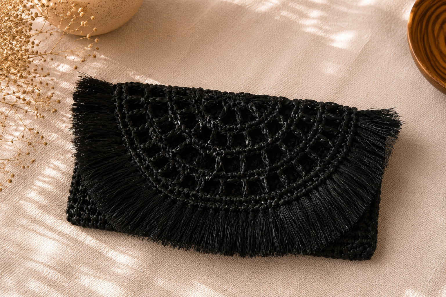Handcrafted black raffia crochet clutch bag with fringe detailing